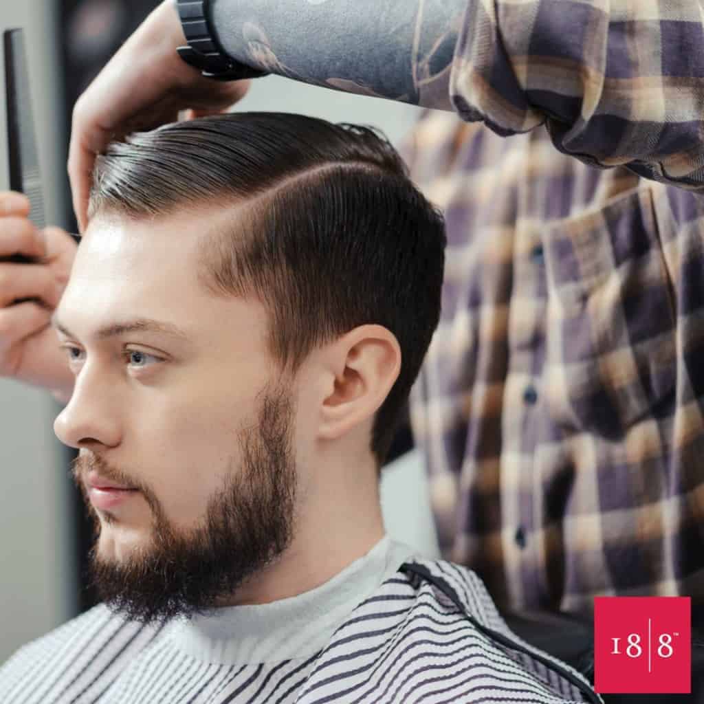 Man Getting Hair Styled At Barbershop