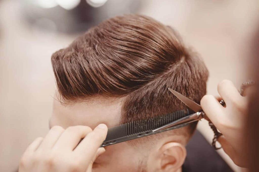 Clean men's haircut, short styles create the illusion of fuller hair
