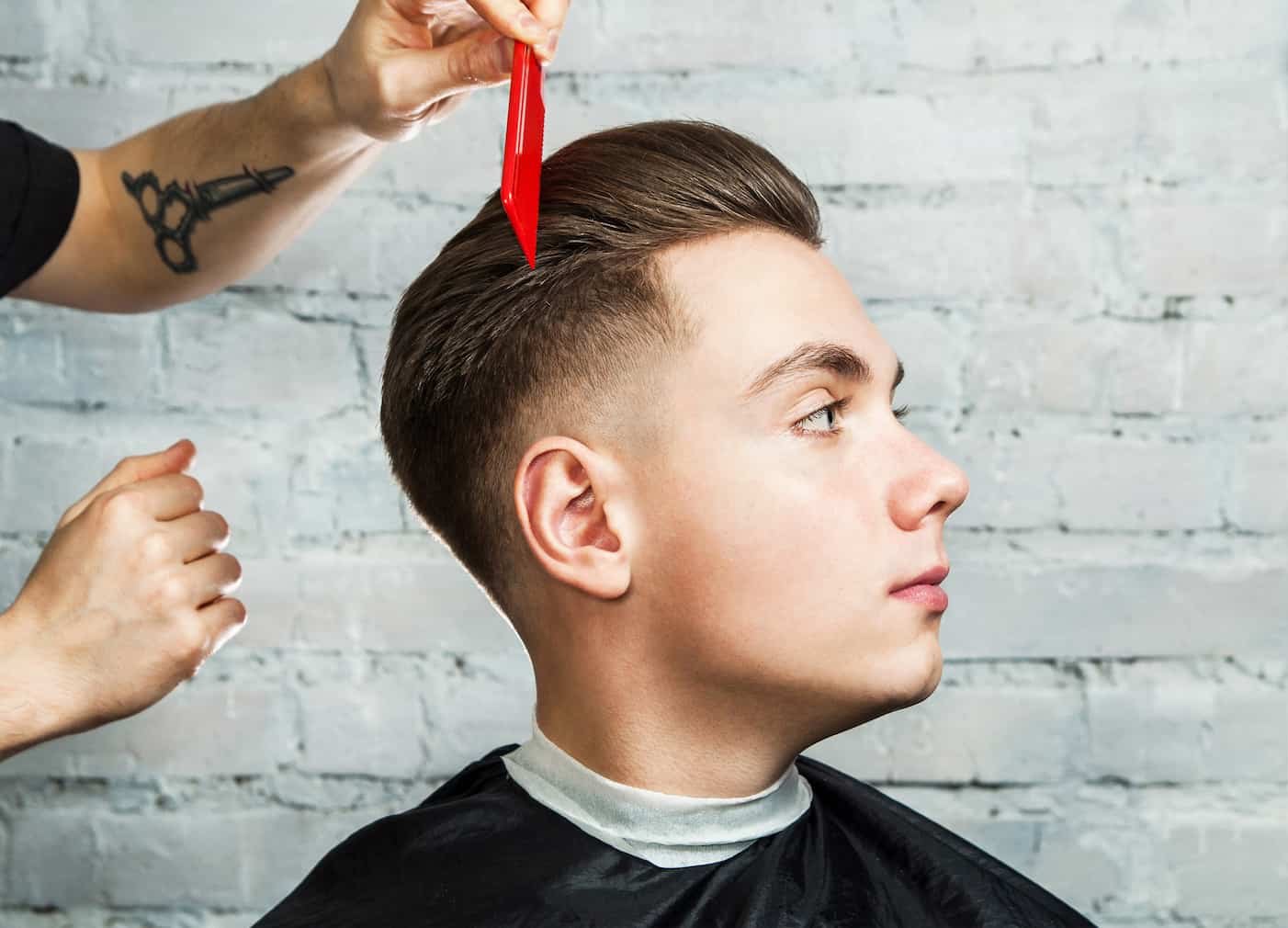 Clean side part with tapered sides at 18|8 Fine Men's Salons